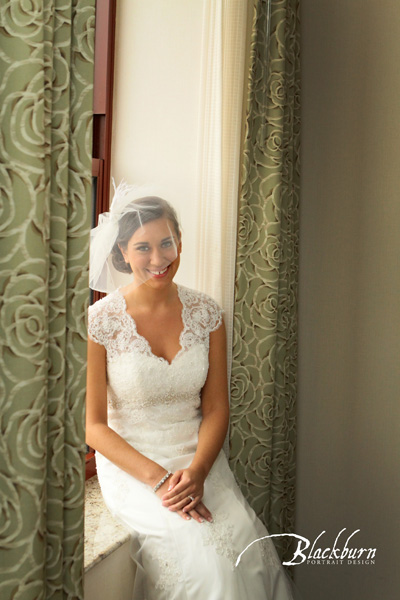 Bride wearing veil seated in the window at the Hampton Inn Saratoga NY